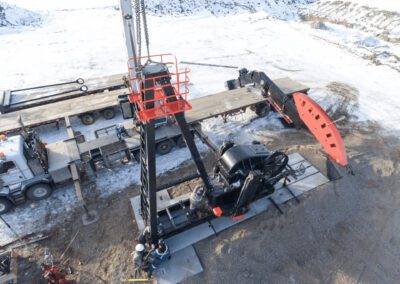 A large crane is engaged in lifting heavy equipment